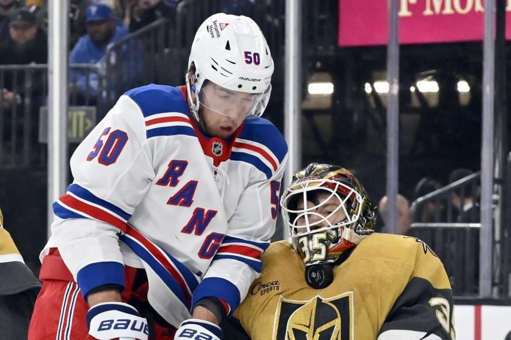 Vegas Golden Knights goaltender Ilya Samsonov, right, blocks the puck against New York Rangers left wing Will Cuylle (50) during the first period of an NHL hockey game Saturday, Jan. 11, 2025, in Las Vegas. (AP Photo/David Becker)