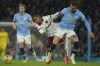 West Ham's Crysencio Summerville, left, and Manchester City's Kyle Walker battle for the ball during a English Premier League soccer match at Etihad stadium in Manchester, England, Saturday, Jan. 4, 2025. (AP Photo/Ian Hodgson)