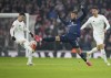 Manchester United's Noussair Mazraoui, centre, challenges for the ball with Arsenal's Gabriel Martinelli, left, during the English FA Cup soccer match between Arsenal and Manchester United at the Emirates stadium in London, Sunday, Jan. 12, 2025. (AP Photo/Kin Cheung)