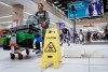 Travellers manoeuvre around buckets catching leaks as repairs are underway at the Calgary International Airport after parts of its domestic terminal building were closed late Monday due to damage caused by hail and heavy rainfall, in Calgary on Tuesday, Aug. 6, 2024. THE CANADIAN PRESS/Jeff McIntosh