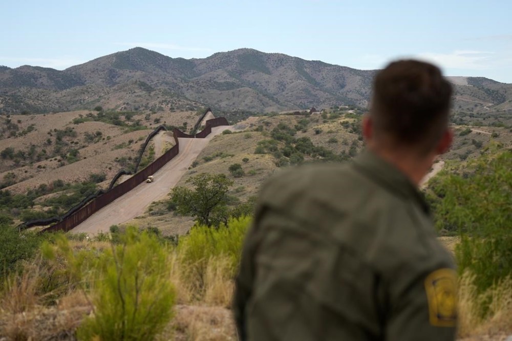 FILE - Border patrol agent Pete Bidegain looks from a hilltop on the U.S. side of the US-Mexico border in Nogales, Ariz., June 25, 2024. (AP Photo/Jae C. Hong, Pool, File)