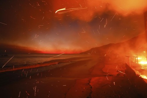 FILE - The Palisades Fire burns a beach front property, Jan. 8, 2025, in Malibu, Calif. (AP Photo/Etienne Laurent, File)