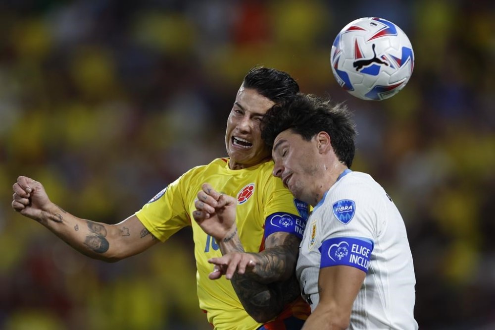 FILE - Colombia's James Rodriguez, left, and Uruguay's Jose Gimenez jump for a header during a Copa America semifinal soccer match in Charlotte, N.C., July 10, 2024. (AP Photo/Nell Redmond, File)