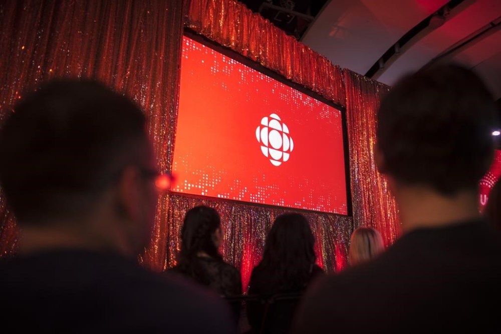 The CBC logo is projected onto a screen during the CBC's annual upfront presentation at The Mattamy Athletic Centre in Toronto, Wednesday, May 29, 2019. THE CANADIAN PRESS/Tijana Martin
