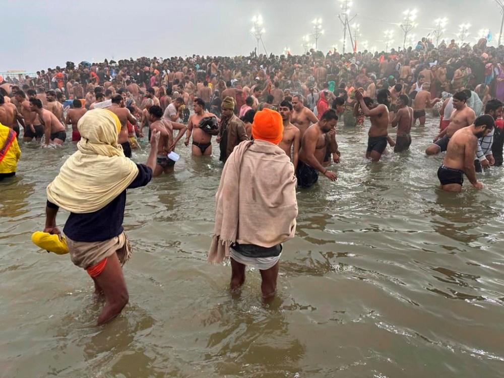 Hindus take holy dips at the confluence of the Ganges, the Yamuna and the mythical Saraswati rivers on Makar Sankranti, an auspicious bathing day of the 45-day-long Maha Kumbh festival in Prayagraj, India, Tuesday, Jan. 14, 2025. (AP Photo/Ashwini Bhatia)