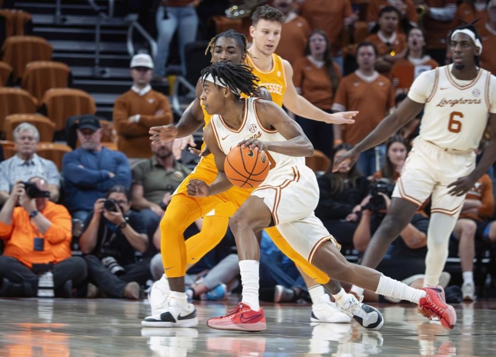 Texas guard Tre Johnson, front, drives the ball against Tennessee guard Jahmai Mashack, back, during the first half an NCAA college basketball game, Saturday, Jan. 11, 2025, in Austin, Texas. (AP Photo/Michael Thomas)