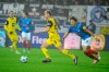 Dortmund's Julian Ryerson, centre, and Kiel's Shuto Machino fight for the ball during the Bundesliga soccer match between Holstein Kiel and Borussia Dortmund at the Holstein Stadium in Kiel, Germany, Tuesday, Jan. 14, 2025. (Gregor Fischer/dpa via AP)