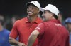 Tiger Woods, left, talks to his Jupiter Link Golf Club teammate Kevin Kisner before the start of a match against the Los Angeles Golf Club, Tuesday, Jan. 14, 2025, in Palm Beach Gardens, Fla. (AP Photo/Marta Lavandier)