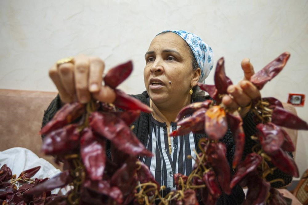 Chahida Boufaied, owner of Dar Chahida Lel Oula, prepares the Harissa in her house in Nabeul, Tunisia, Tuesday, Jan. 7, 2025. (AP Photo/Ons Abid)