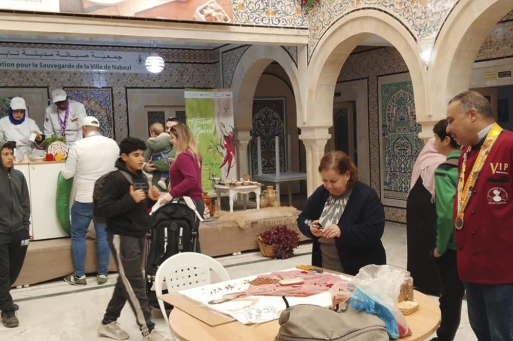 In this photo provided by the ASVN (Association pour la Sauvegarde de la Ville de Nabeul), people visit the Harissa Festival in Nabeul, Tunisia, Jan. 3, 2025. (Zouheir Denguir/ASVN Nabeul via AP)