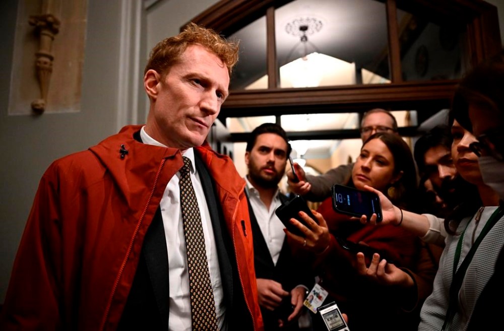Minister of Immigration, Refugees and Citizenship Marc Miller takes questions as he arrives at a cabinet meeting in Ottawa, on Tuesday, Nov. 26, 2024. THE CANADIAN PRESS/Justin Tang