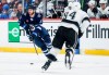 Winnipeg Jets' Kyle Connor (81) looks to make a pass as Los Angeles Kings' Vladislav Gavrikov (84) defends during second period NHL action in Winnipeg, Friday, Jan. 10, 2025. THE CANADIAN PRESS/John Woods