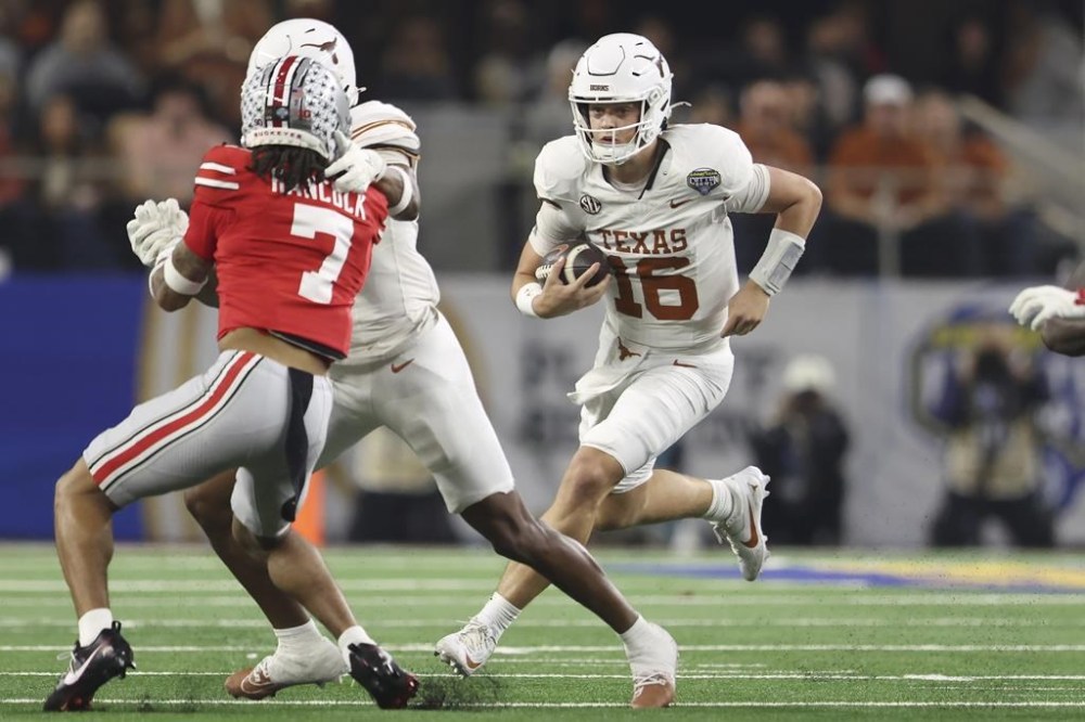 Texas quarterback Arch Manning (16) runs against Ohio State during the first half of the Cotton Bowl College Football Playoff semifinal game, Friday, Jan. 10, 2025, in Arlington, Texas. (AP Photo/Gareth Patterson)