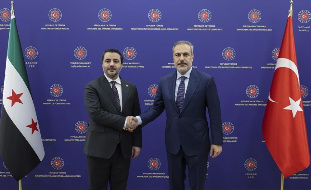 In this handout photo released by the Turkish Foreign Ministry, Turkish Foreign Minister Hakan Fidan, right, shakes hands with Syria's new Foreign Minister, Asaad al-Shibani, prior to holding a press conference in Ankara, Turkey, Wednesday, Jan. 15, 2025. (Turkish Foreign Ministry Press Service via AP)