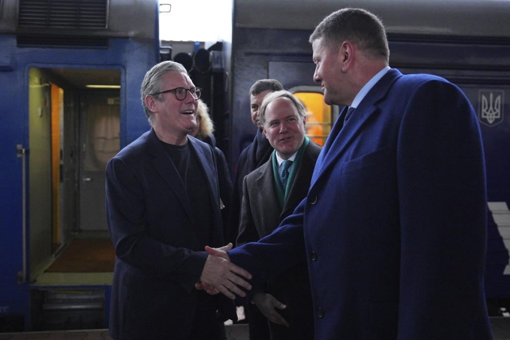 British Prime Minister Keir Starmer, left, is greeted by Ukrainian officials and the British ambassador to Ukraine Martin Harris, second right, as he arrives at a train station in Kyiv, Ukraine Thursday, Jan. 16, 2025. (Carl Court/Pool Photo via AP)