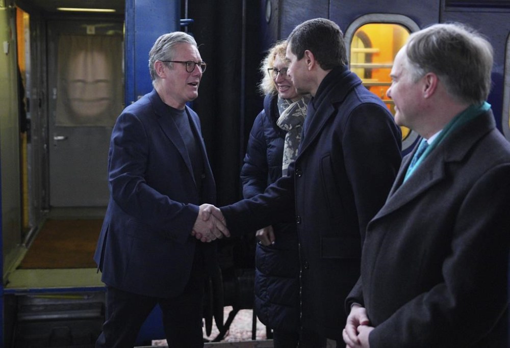 British Prime Minister Keir Starmer, left, is greeted by Ukrainian officials and the British ambassador to Ukraine Martin Harris, right, as he arrives at a train station in Kyiv, Ukraine Thursday, Jan. 16, 2025. (Carl Court/Pool Photo via AP)