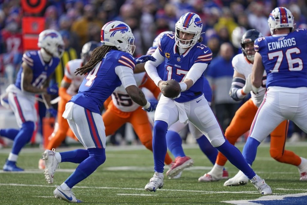 Buffalo Bills quarterback Josh Allen (17) hands off the ball to running back James Cook (4) during the first quarter of an NFL wild card playoff football game, Sunday, Jan. 12, 2025, in Orchard Park, N.Y. (AP Photo/Seth Wenig)