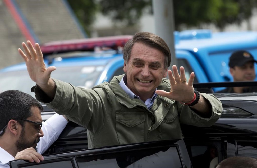 FILE - Jair Bolsonaro, a presidential candidate of the Social Liberal Party, waves after voting in the presidential runoff election in Rio de Janeiro, Oct. 28, 2018. (AP Photo/Silvia Izquierdo, File)
