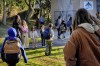 Palisades Charter Elementary School students and their parents arrive at their new school, the Brentwood Elementary Science Magnet school in the Brentwood section of Los Angeles on Wednesday, Jan. 15, 2025. (AP Photo/Richard Vogel)