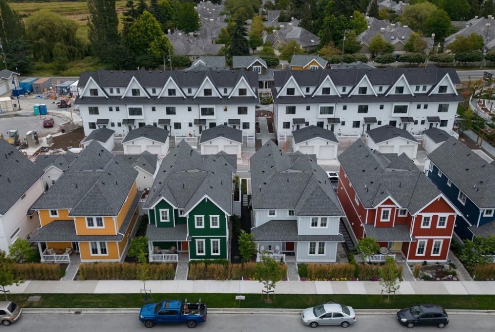 New single family houses billed as estate cottages and townhouses under construction are seen in an aerial view, in Delta, B.C., on Monday, Aug. 12, 2024. THE CANADIAN PRESS/Darryl Dyck