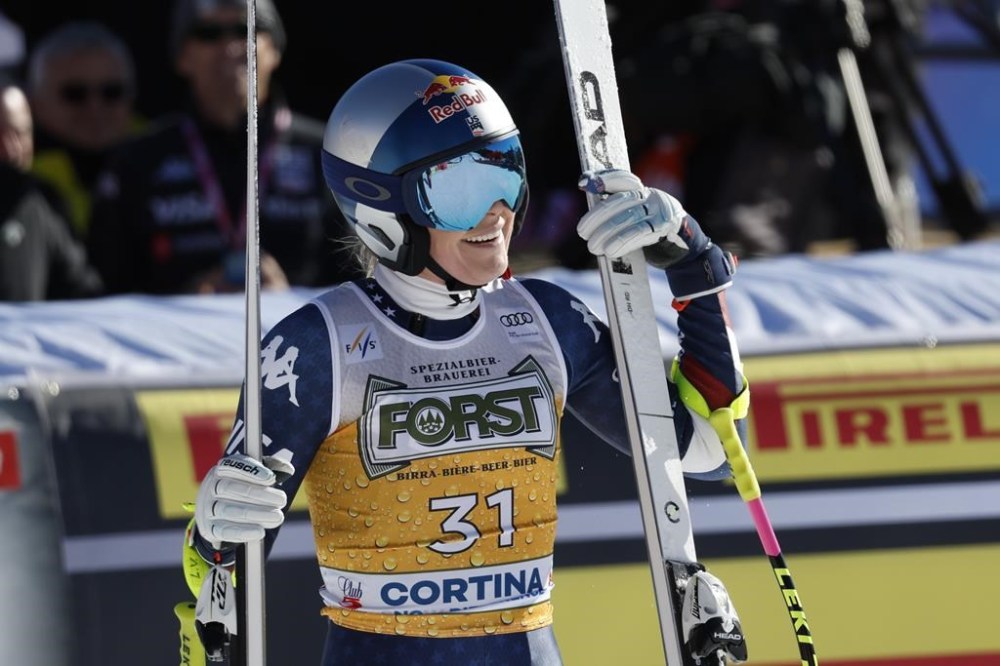 United States' Lindsey Vonn celebrates at the finish area of an alpine ski, women's World Cup downhill, in Cortina d'Ampezzo, Italy, Saturday, Jan. 18, 2025 (AP Photo/Alessandro Trovati)
