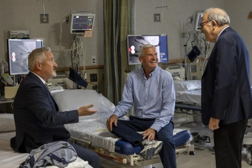 In this photo provided by Massachusetts General Hospital, patient Mike Garrity, center, speaks with Drs. Joe Garasic, left, and Randy Zusman in Boston, on Sept. 25, 2024. (Jeffrey Andree/Massachusetts General Hospital via AP)