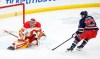 Calgary Flames goaltender Dustin Wolf (32) stops the shot from Winnipeg Jets' Nikolaj Ehlers (27) during first period NHL action in Winnipeg on Saturday, Jan. 18, 2025. THE CANADIAN PRESS/John Woods