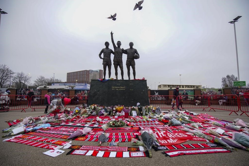 A statue of Manchester United trio of George Best, left, Denis Law, center, and Sir Bobby Charlton is seen prior the English Premier League soccer match between Manchester United and Brighton and Hove Albion, at the Old Trafford stadium in Manchester, England, Sunday, Jan. 19, 2025. (AP Photo/Dave Thompson)