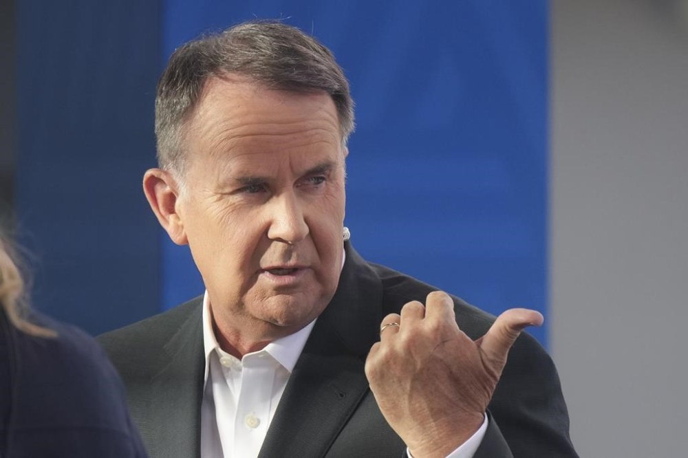 Television presenter Tony Jones during a live cross at Melbourne Park venue for the Australian Open tennis championship in Melbourne, Australia, Monday, Jan. 20, 2025. (AP Photo/Mark Baker)