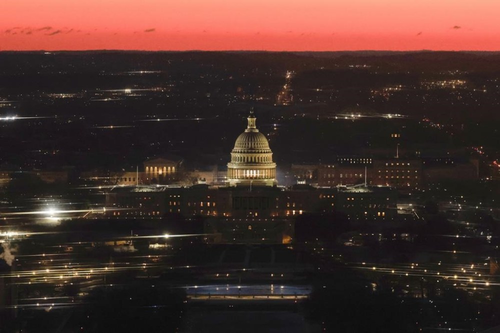 The U.S. Capitol is seen from the top of the Washington Monument at dawn on Inauguration Day, Monday, Jan.20, 2025 in Washington. (Brendan McDermid/Pool via AP)