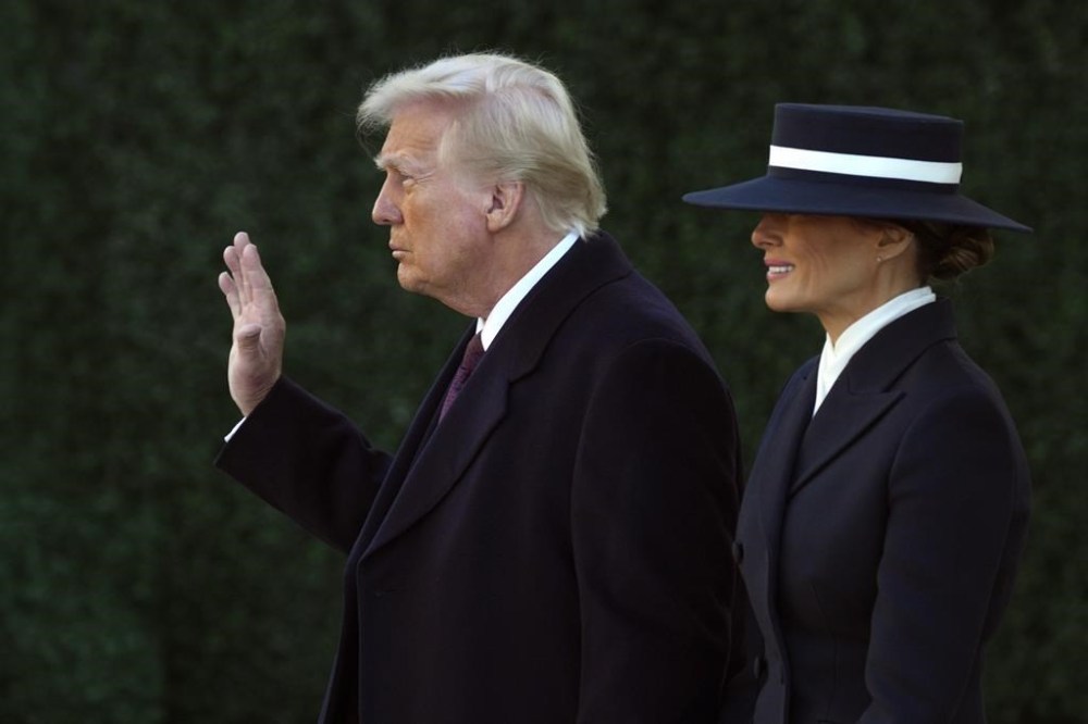 President-elect Donald Trump waves as he walks with his wife Melania after a church service at St. John's Episcopal Church across from the White House in Washington, Monday, Jan. 20, 2025, on Donald Trump's inauguration day. (AP Photo/Matt Rourke)