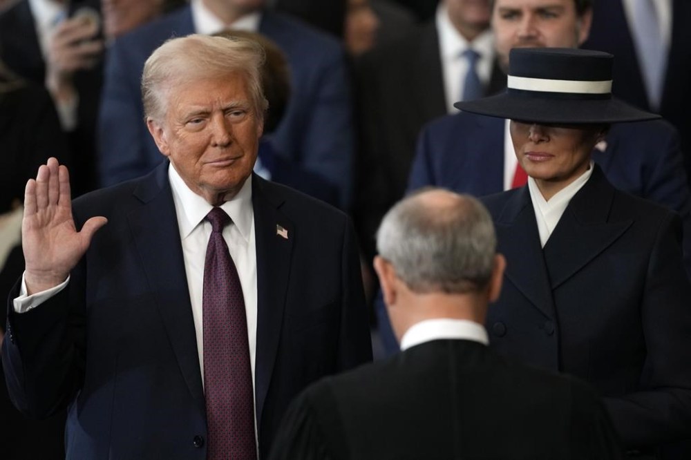 Donald Trump is sworn in as the 47th president of the United States by Chief Justice John Roberts as Melania Trump holds the Bible during the 60th Presidential Inauguration in the Rotunda of the U.S. Capitol in Washington, Monday, Jan. 20, 2025. (AP Photo/Julia Demaree Nikhinson, Pool)