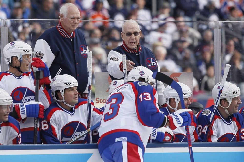 Winnipeg Jets Alumni coach Tom McVie picks Teemu Selanne (13) to take the penalty shot as Ab McDonald listens in against the Edmonton Oilers at Investors Group Field in the first period of the NHL Heritage Classic Alumni game in Winnipeg on Saturday, October 22, 2016. THE CANADIAN PRESS/John Woods