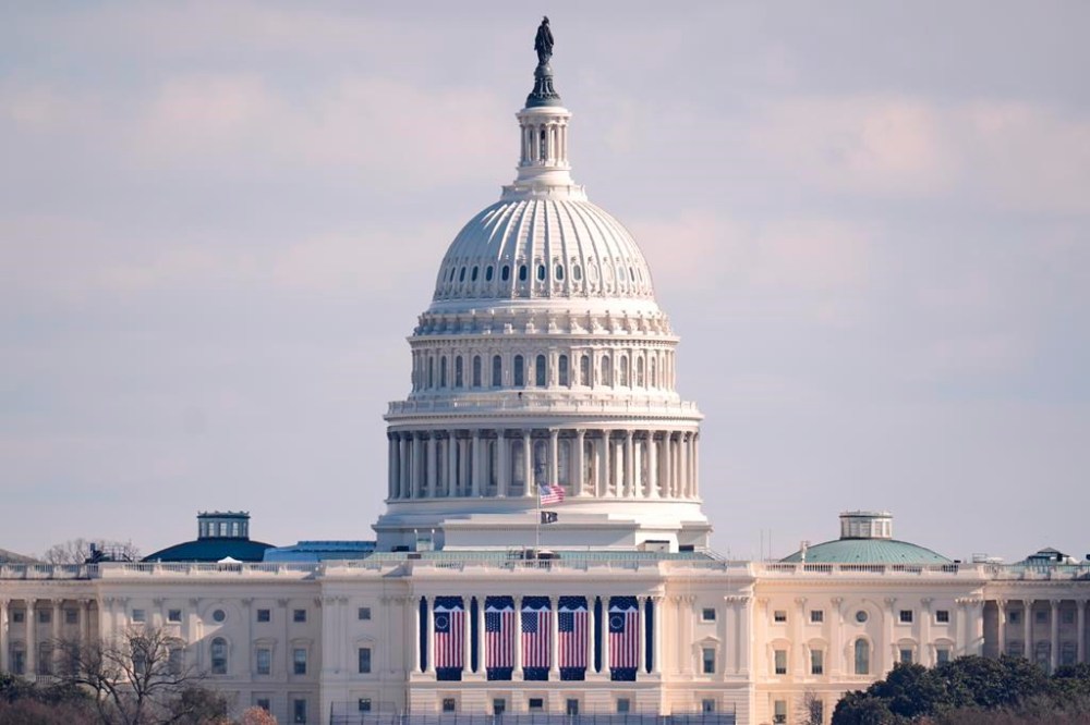 The U.S. flag at the U.S. Capitol is at full height on the day of the 60th Presidential Inauguration, Monday, Jan. 20, 2025, in Washington. Flags are supposed to fly at half-staff through the end of January out of respect for former President Jimmy Carter, who died Dec. 29, 2024. (AP Photo/Mike Stewart)
