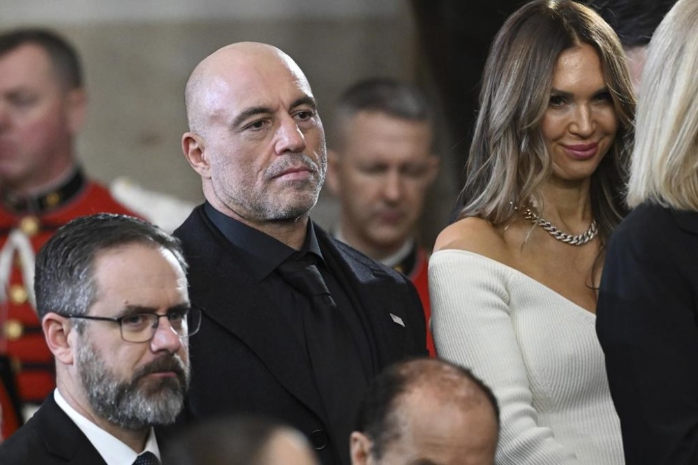 Joe Rogan stands for a benediction after President Donald Trump was sworn in during the 60th Presidential Inauguration in the Rotunda of the U.S. Capitol in Washington, Monday, Jan. 20, 2025. (Saul Loeb/Pool photo via AP)
