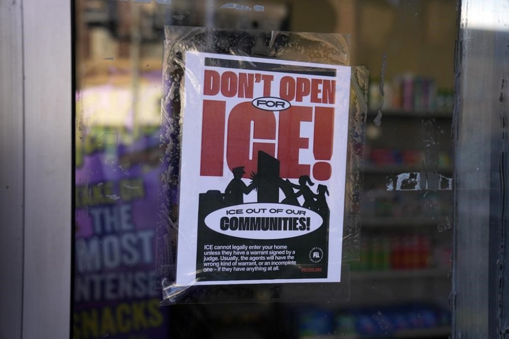 A sign regarding the U.S. Immigration and Customs Enforcement is posted on the window of a corner store on the day of President Trump's Inauguration, Monday, Jan. 20, 2025, in the predominantly Latino Little Village neighborhood Chicago. (AP Photo/Erin Hooley)