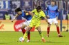 Kiel's Shuto Machino, left, and Hoffenheim's Tom Bischof fight for the ball during the German Bundesliga soccer match between Holstein Kiel and TSG 1899 Hoffenheim in Kiel, Germany, Saturday, Jan. 18, 2025. (Axel Heimken/dpa via AP)