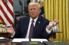 President Donald Trump talks to reporters as he signs executive orders in the Oval Office of the White House, Monday, Jan. 20, 2025, in Washington. (AP Photo/Evan Vucci)