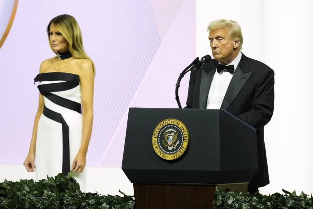President Donald Trump speaks as first lady Melania Trump listens at the Commander in Chief Ball, Monday, Jan. 20, 2025, in Washington. (AP Photo/Alex Brandon)