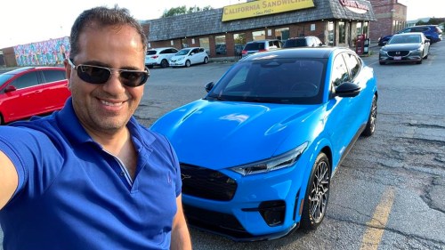 Longtime EV owner and auto journalist Michael Bettencourt test driving — and colour-matching — the 2022 Ford Mustang Mach-E GT EV in Etobicoke, Ont. In a July, 2022 handout photo. THE CANADIAN PRESS/HO-Michael Bettencourt **MANDATORY CREDIT**