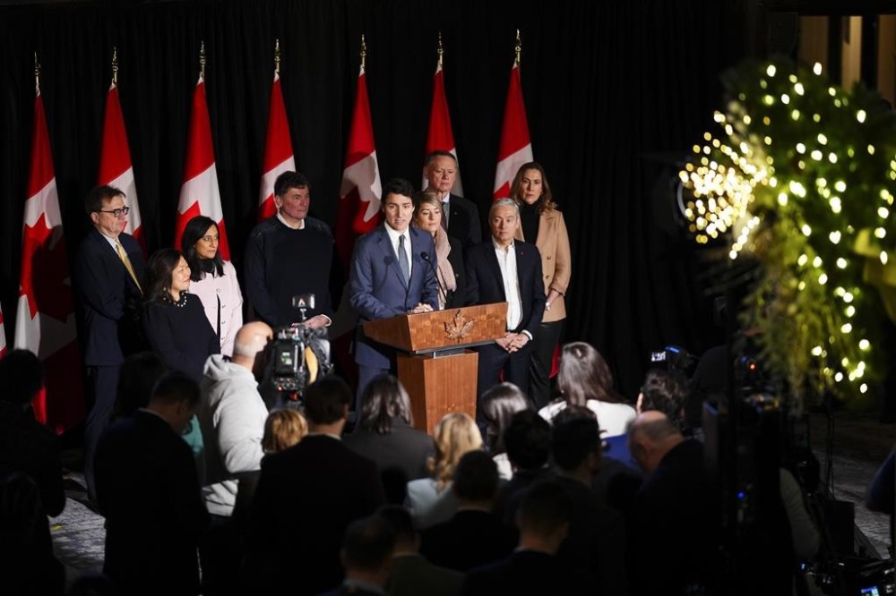 Prime Minister Justin Trudeau stands with members of his cabinet and Kirsten Hillman, Canada's ambassador to the U.S., as he holds a press conference during a cabinet retreat at Chateau Montebello in Montebello, Que., on Tuesday, Jan. 21, 2025. THE CANADIAN PRESS/Sean Kilpatrick