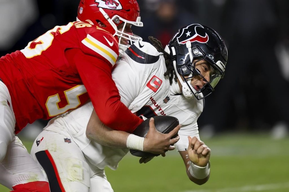 Houston Texans quarterback C.J. Stroud, right, is sacked by Kansas City Chiefs defensive end George Karlaftis (56) during the second half of an NFL football divisional playoff game, Saturday, Jan. 18, 2025 in Kansas City, Mo. The Chiefs continue to be a popular pick with Proline bettors. The Chiefs began their quest for a third straight Super Bowl title with a 23-14 win over the Houston Texans on Saturday in the NFL divisional playoffs. THE CANADIAN PRESS/AP/Reed Hoffmann