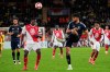 Aston Villa's Tyrone Mings, right, passes the ball as Monaco's Denis Zakaria defends during a Champions League opening phase soccer match between Monaco and Aston Villa at the Louis II stadium in Monaco, Tuesday, Jan. 21, 2025. (AP Photo/Laurent Cipriani)