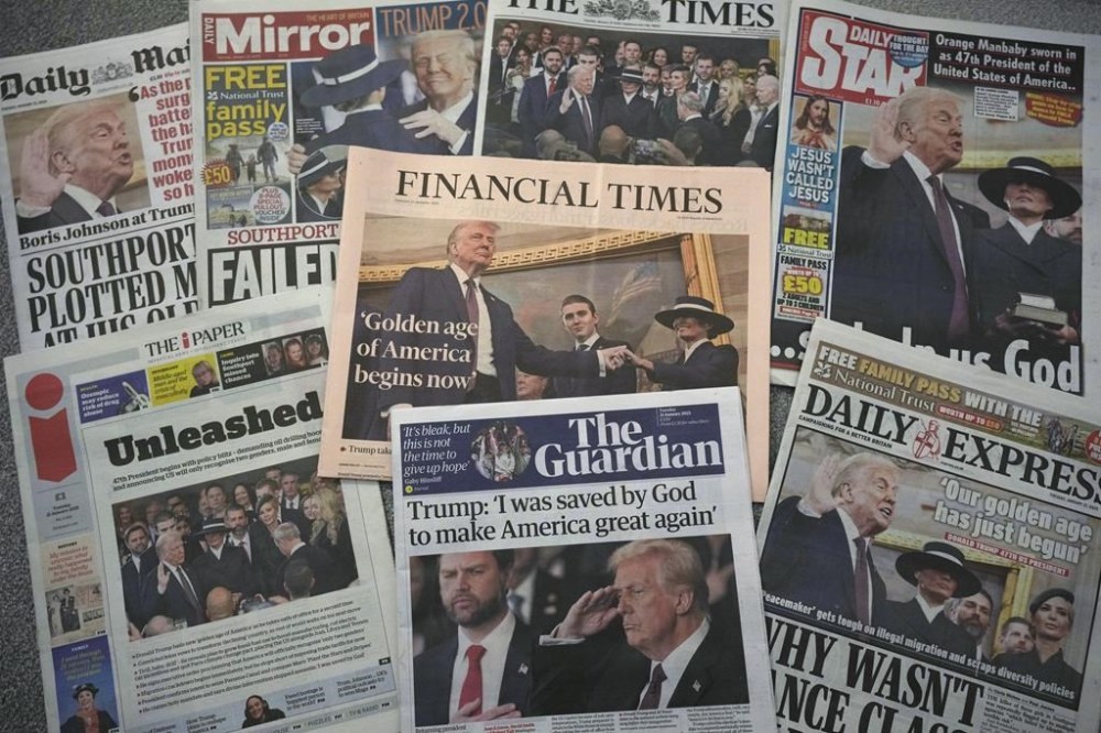 A selection of British national newspaper front pages showing reaction to President Trump's Inauguration in London, Tuesday, Jan. 21, 2025. (AP Photo/Alastair Grant)