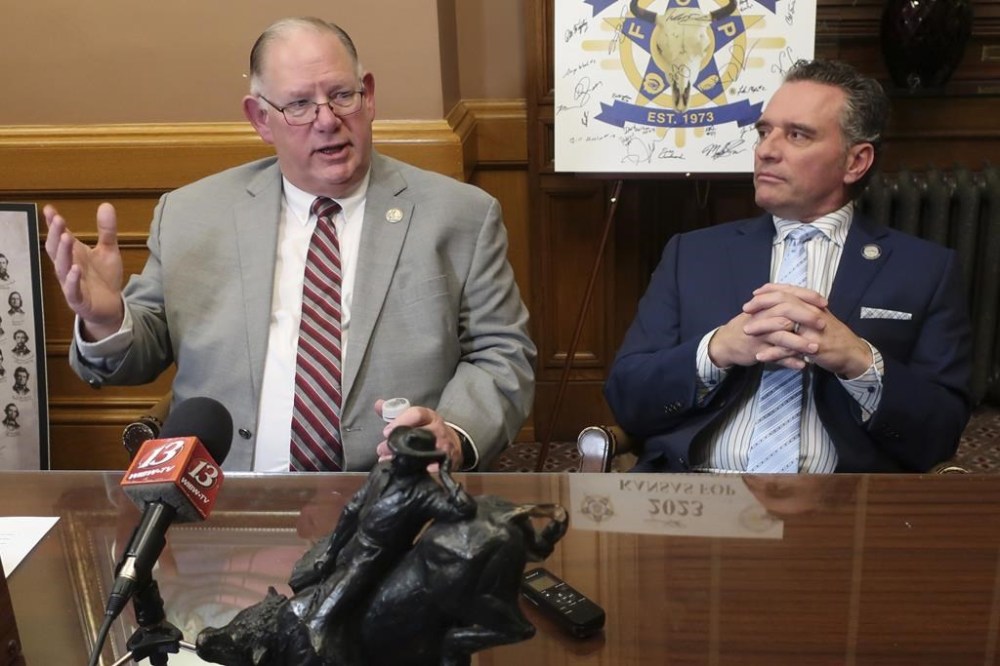 Kansas House Speaker Dan Hawkins, left, R-Wichita, speaks to reporters during a news conference following the annual State of the State address, as Senate President Ty Masterson, right, R-Andover, watches, Wednesday, Jan. 15, 2025, at the Statehouse in Topeka, Kan. (AP Photo/John Hanna)
