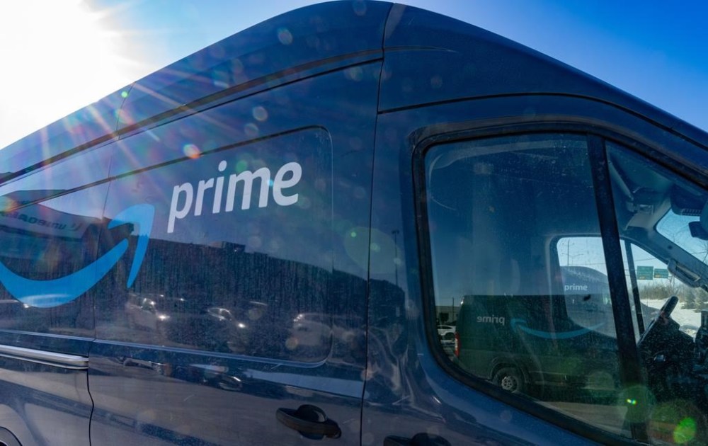 Delivery trucks are parked outside Amazon's DXT4 warehouse in Laval, Que., Wednesday, Jan. 22, 2025. Amazon Canada says it is closing all seven of its warehouses in Quebec. THE CANADIAN PRESS/Christinne Muschi