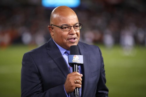 FILE - In this Sept. 5, 2019, file photo, NBC sportscaster Mike Tirico works the sidelines during an NFL football game between the Green Bay Packers and the Chicago Bears in Chicago. (AP Photo/Jeff Haynes, File)