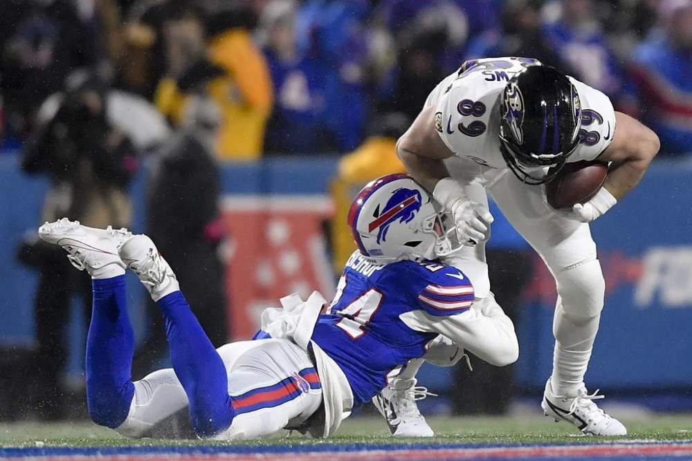 Buffalo Bills safety Cole Bishop (24) tackles Baltimore Ravens tight end Mark Andrews (89) during the third quarter of an NFL divisional playoff football game, Sunday, Jan. 19, 2025, in Orchard Park, N.Y. (AP Photo/Adrian Kraus)