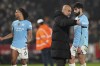Manchester City's head coach Pep Guardiola, left right, talks with his player Manchester City's Josko Gvardiol during the English Premier League soccer match between Brentford and Manchester City at the Gtech Community stadium, in London, England, Tuesday, Jan. 14, 2025. (AP Photo/Alastair Grant)