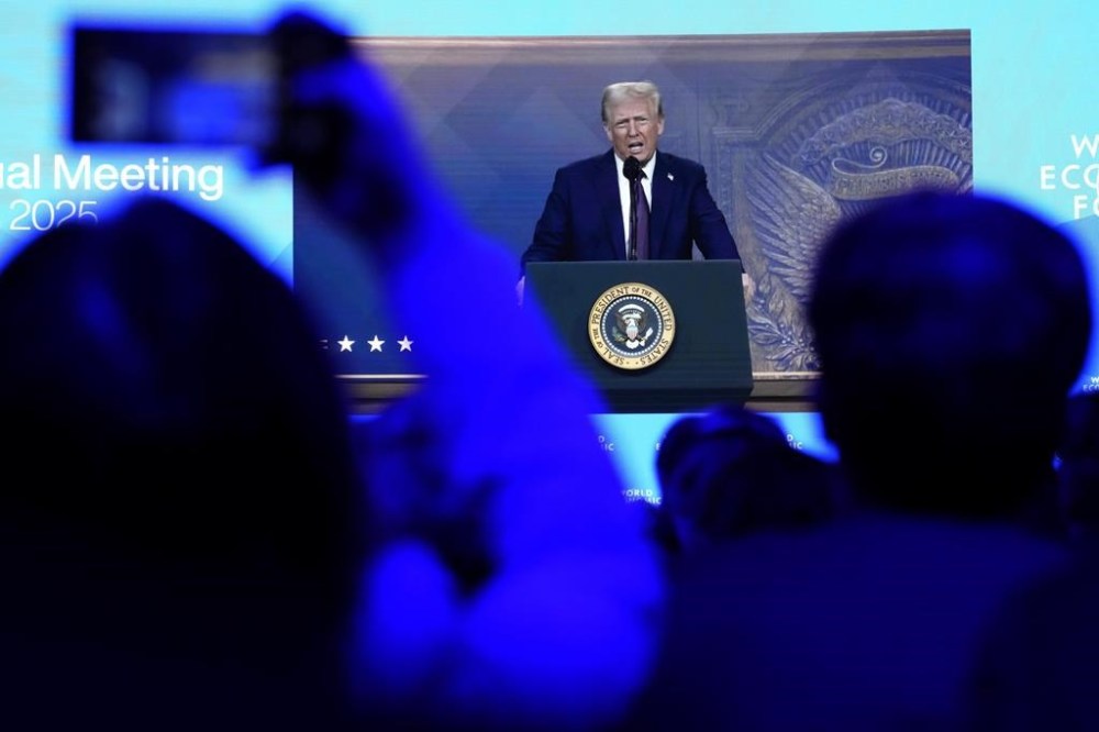 People follow a virtual speech of U.S. president Donald Trump at the Annual Meeting of World Economic Forum in Davos, Switzerland, Thursday, Jan. 23, 2025. THE CANADIAN PRESS/AP-Markus Schreiber
